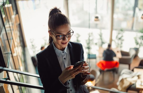Top view of young businesswoman using technology.