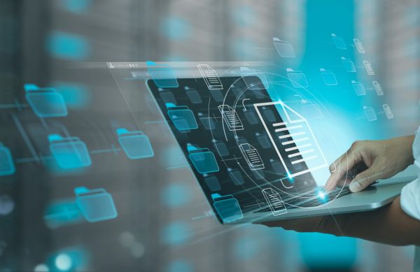 Businessman working modern compter Document Management System (DMS),Virtual online documentation database and process automation to efficiently manage files, knowledge and documentation in enterprise with ERP.