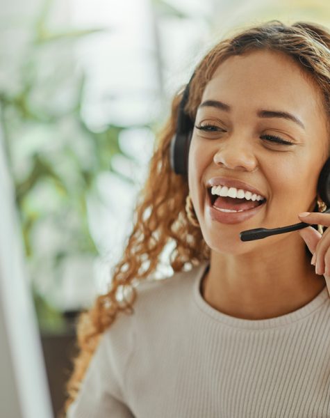 Customer service, happy and communication of woman at call center pc talking with joyful smile. Consultant, advice and help desk girl speaking with clients online with computer headset mic.
