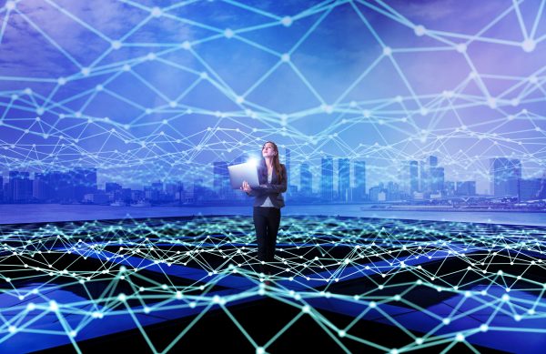 Young woman standing with laptop PC and mesh communication network concept. Internet of Things. Smart city. Information Communication Technology.